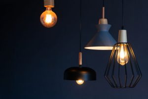 "Lampu gantung bergaya modern dengan desain unik dan pencahayaan hangat di latar belakang gelap
